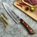 A Caveman Butcher Knife Set from Seido Knives, showcasing a knife on a cutting board with meat and wheat. 