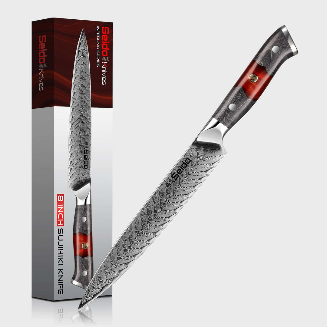 Sujihiki knife with red and black handle next to its packaging on a white background