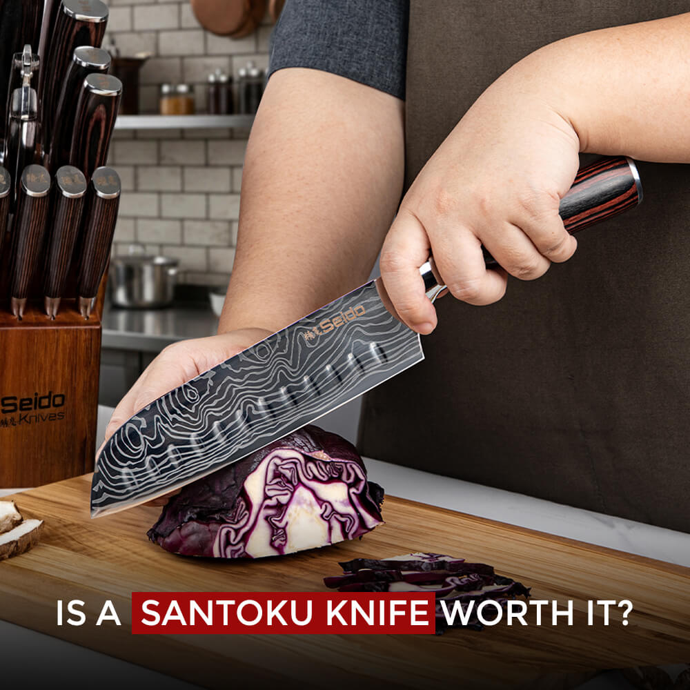 Person slicing red cabbage with a Seido Santoku knife on a wooden cutting board in a kitchen.