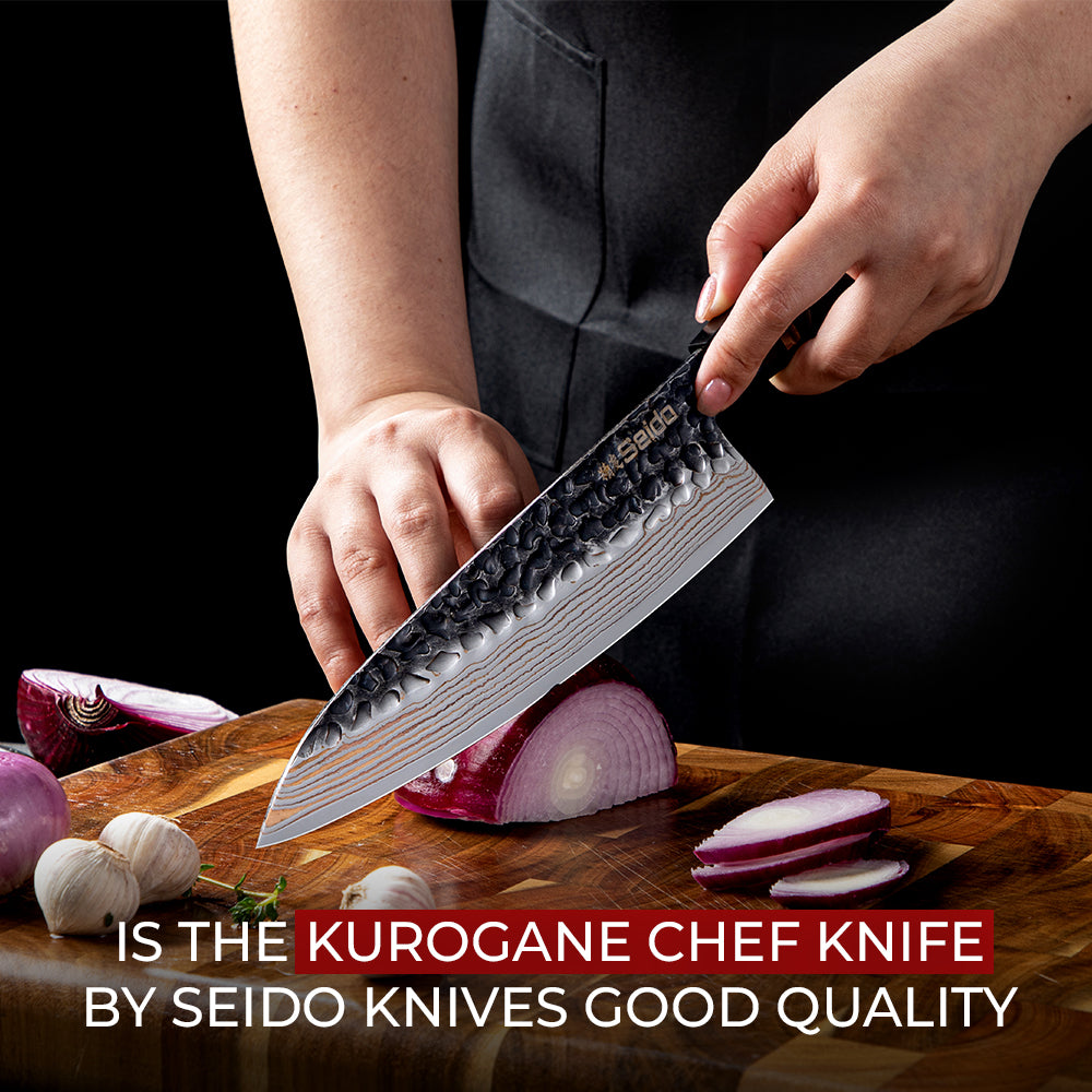 A person using a patterned Seido Kurogane chef knife to slice a red onion on a wooden cutting board.