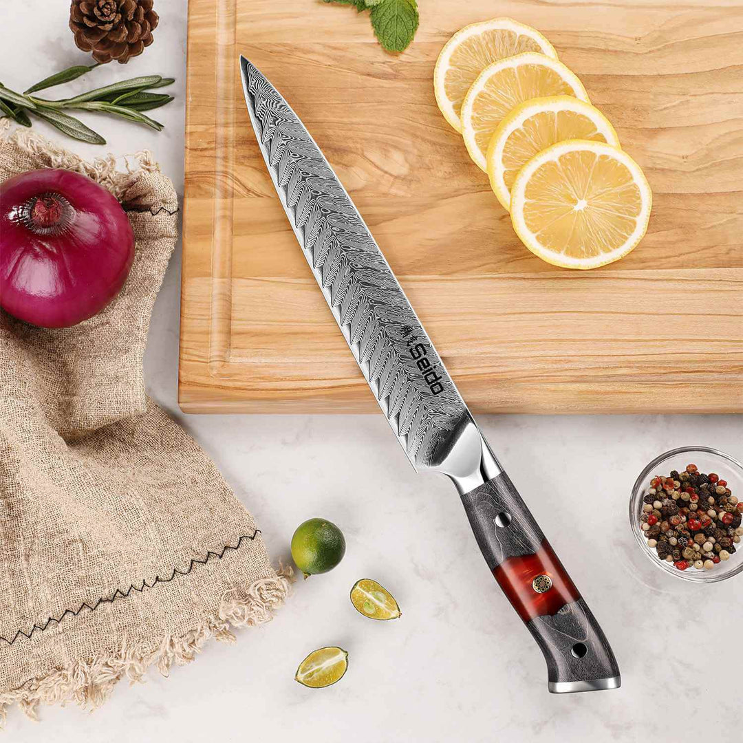 Inferuno Series Sujihiki Slicing Knife on a cutting board with lemons