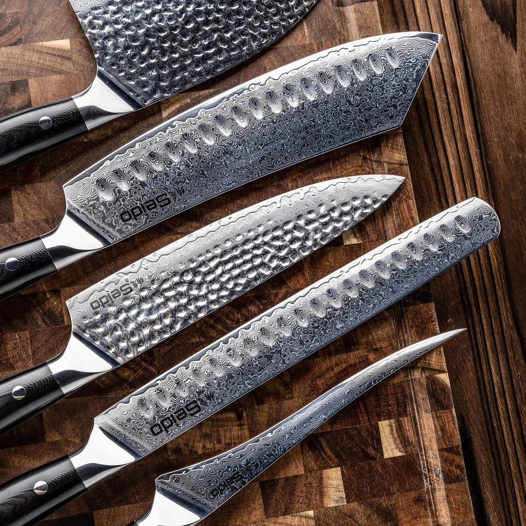 Seido's 5-piece VG-10 steel Shujin knives layed on a cutting board