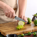 Titan 5-inch Petty Knife being used to slice fresh lime