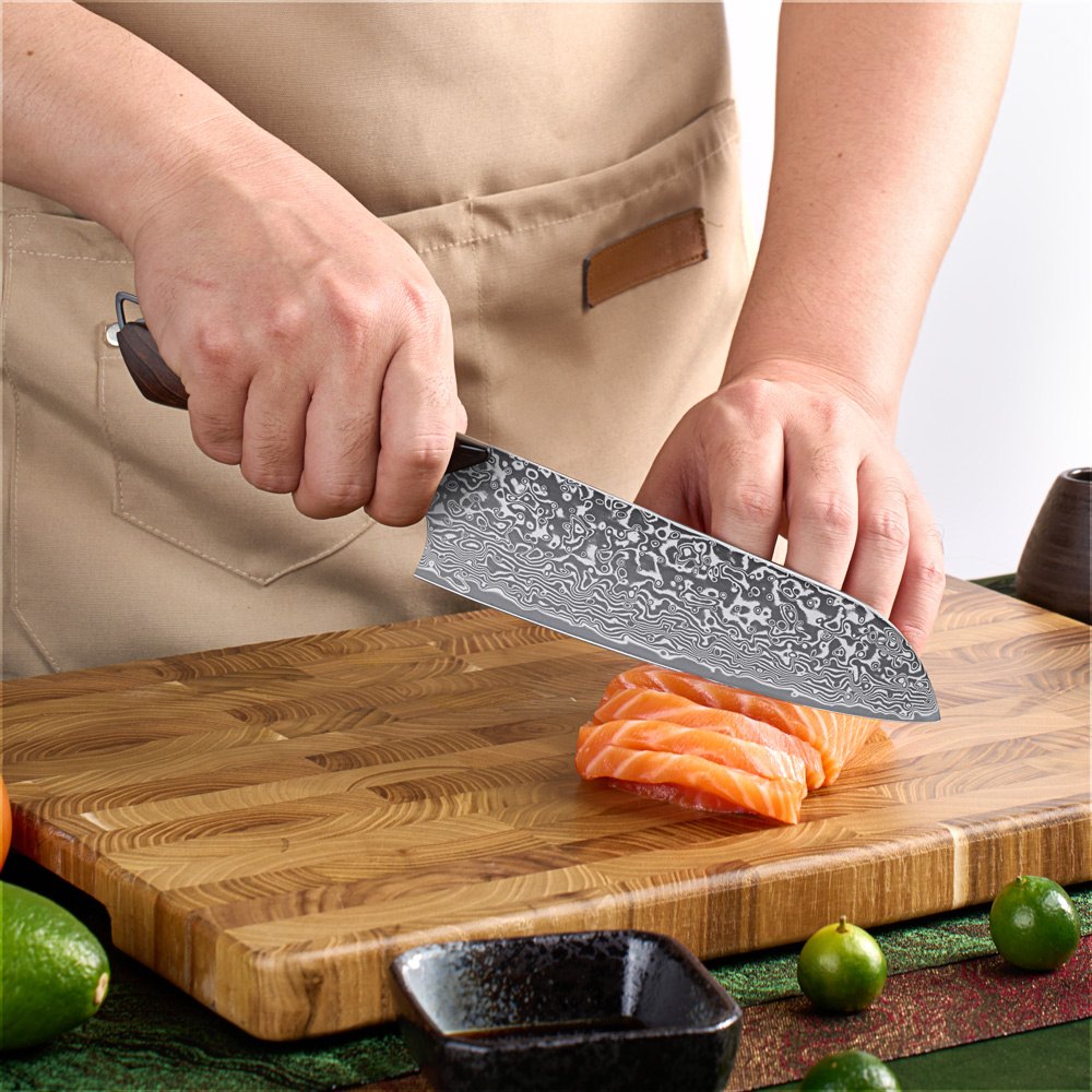 Titan 7-inch Santoku Knife being used to slice salmon