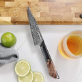 Titan 5-inch Petty Knife beside sliced lime