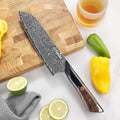 Titan 7-inch Santoku Knife beside citrus and peppers
