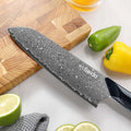 Close-up of the Titan Santoku VG-10 Damascus blade and straight edge