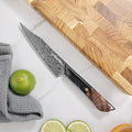 Titan 5-inch Petty Knife on a wooden cutting board