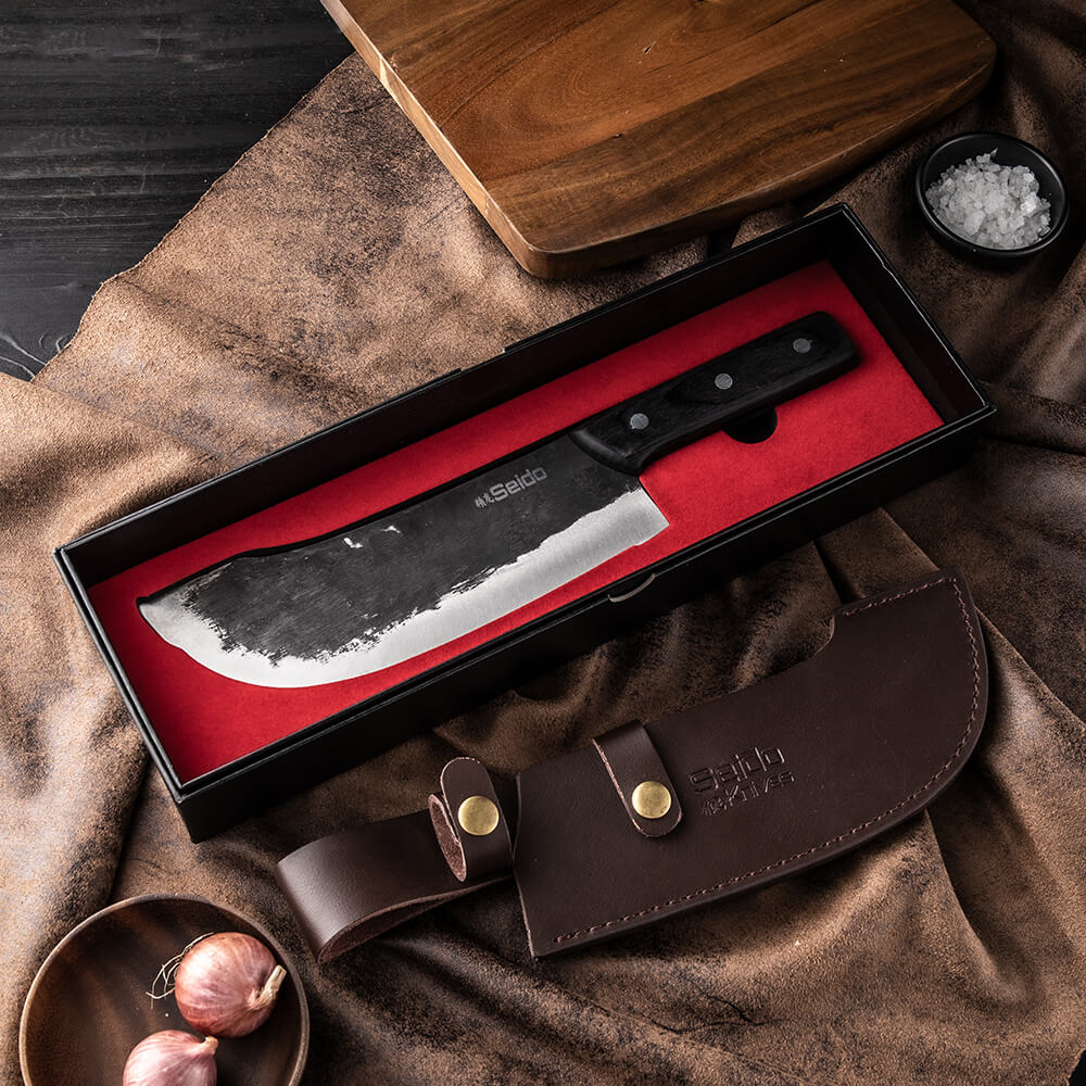 Behold the Nikushoku Butcher Knife by Seido Knives, protected in a leather case and presented in a stylish box.