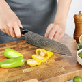 Titan Santoku Knife being used to slice a yellow pepper