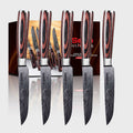 Set of 5 master series steak knives with wooden handles on a white background