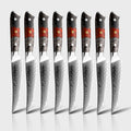Set of 8 steak knives with red and black handles on a white background