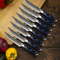 Set of 8 Kanpeki straight edge steak knives with blue & black handles on a wooden surface with vegetables.