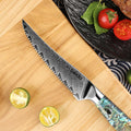 Awabi Serrated Damascus blade detail showing micro-teeth and pattern cladding on a wooden cutting board with vegetables.