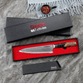  A table with a knife and a gift box, including the Black Executive Gyuto Chef Knife by Seido Knives.