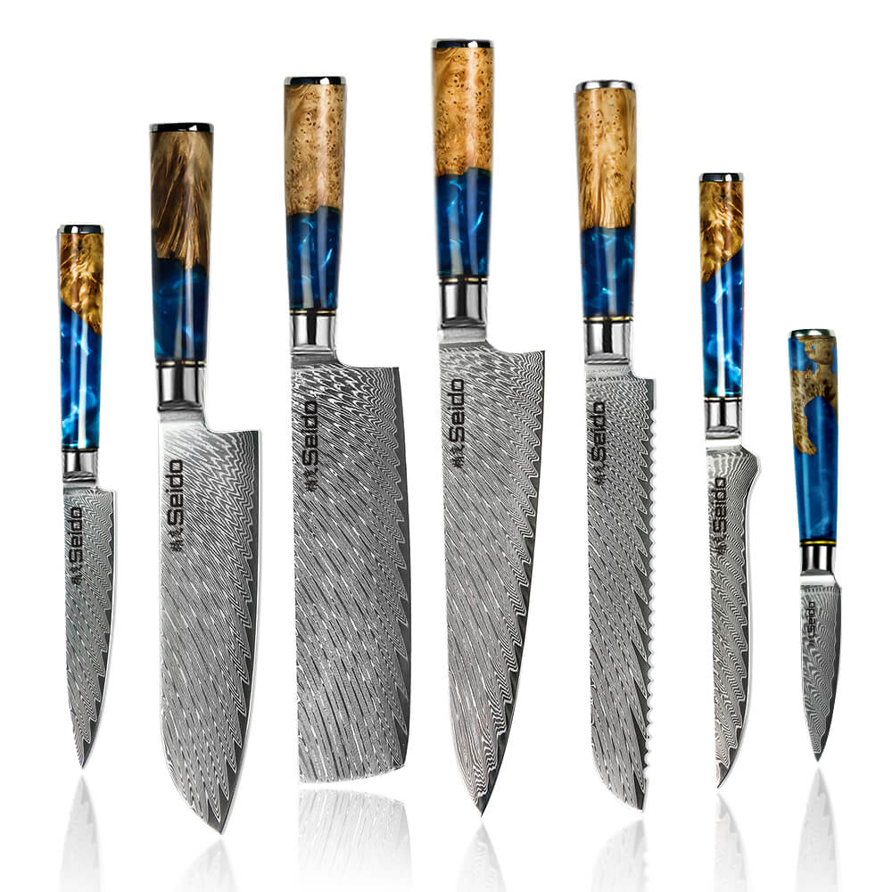 A set of seven knives with blue handles. Get the Executive Japanese Damascus Steel Knife Set from Seido Knives.