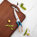 Butterfly kitchen shears with blue handles on a wooden cutting board with green peas.