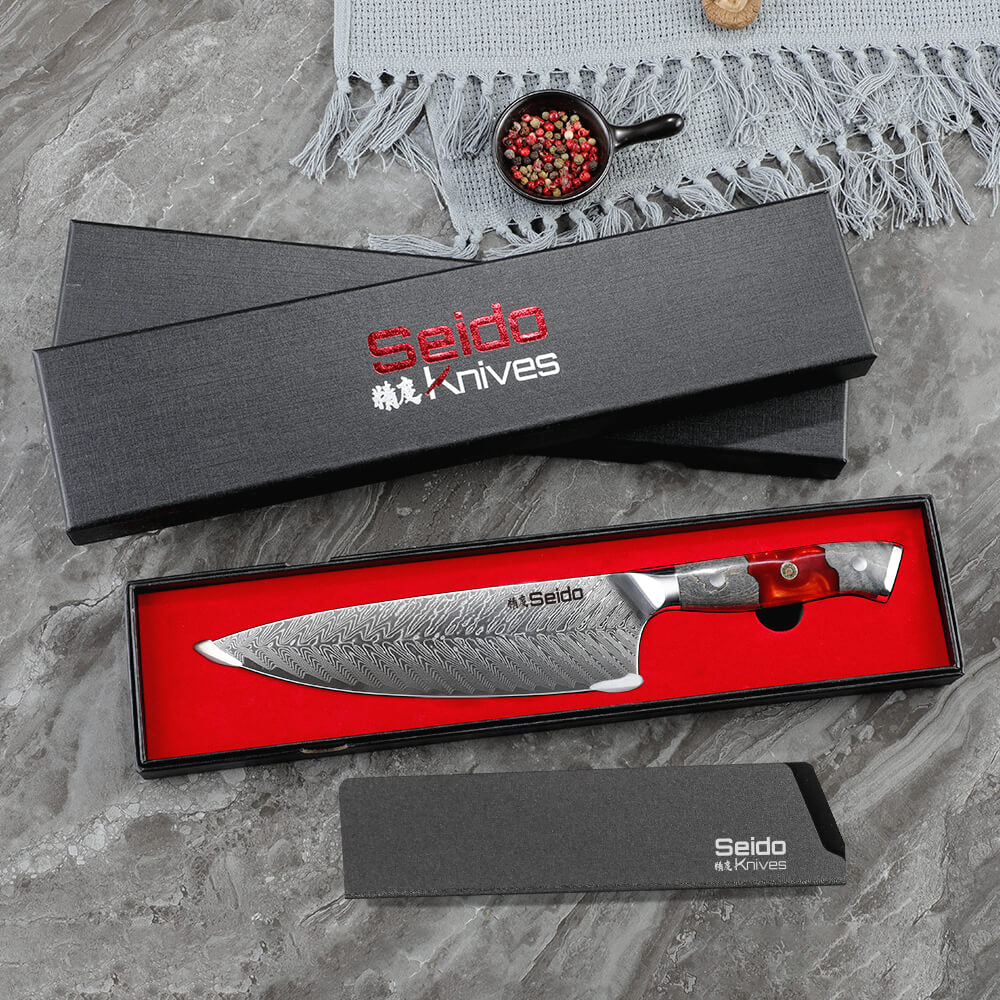 Discover the Inferuno Gyuto AUS10 Chef Knife from Seido Knives, showcased alongside a gift box on a table.