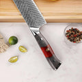 Knife with a decorative handle on a surface with limes and peppercorns