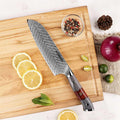 Seido Inferuno Series 7 inch Damascus Santoku Knife on cutting board