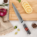 Inferuno Slicing knife with a red handle on a wooden cutting board with lemon slices and vegetables.
