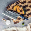 Kanpeki series 7.5-inch Damscus cleaver knife on a wooden cutting board with sliced squash.

