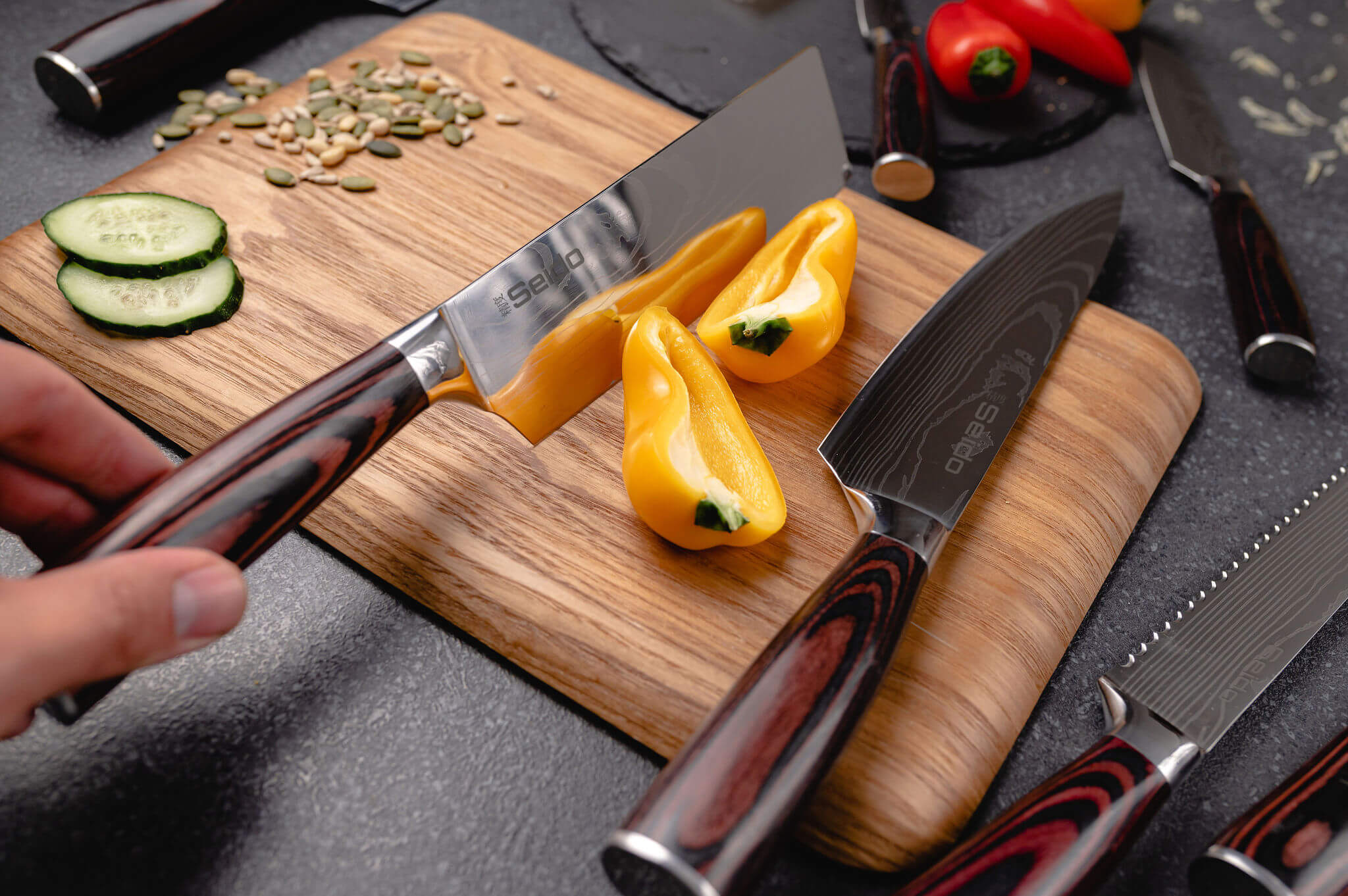 The shimmering blade of a knife by Seido Knives, firmly gripped by someone cutting vegetables.