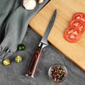 Knife with a decorative handle on a cutting board with vegetables
