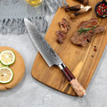 Gyuto Red handle Damascus Steel Chef Knife with knife on a cuttong board surrounded by ingredients.