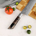 Shinko Nakiri stabilized maple and resin handle detail, on a cutting board with vegetables.