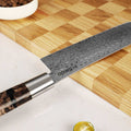 Shinko Series 7 inch Nakiri knife on a cutting board with a bowl of coffee beans and a lime.