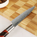 Shinko Series 5 inch Petty Knife details on wooden cutting board.