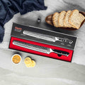 Shujin Series 10-inch serrated knife packaged in a seido gift box, with sliced bread and lemons on a gray surface.