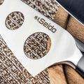 Close-up view of the soft cheeses perforated blade, designed to reduce sticking for smooth, even cuts. 