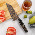 Kurogane 7-inch Bunka knife displayed in a kitchen setting with fresh produce