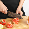 Kurogane 7-inch Bunka knife slicing fresh tomato on a wooden cutting board