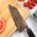 Detailed close-up of the Kurogane Bunka rainbow Damascus blade pattern and cutting edge