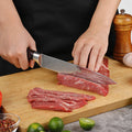 Master 8-inch slicing knife being used to cut thin slices of beef on a wooden cutting board