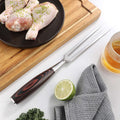 Full Master Series carving fork displayed beside poultry on a carving board