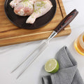 Master carving fork positioned beside seasoned poultry during meal preparation