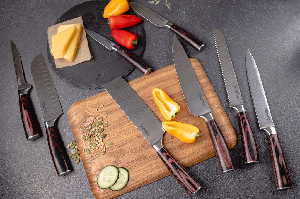 Seido knives' signature 8-piece Japanese master chef knife set displayed on a cutting board with various ingredients
