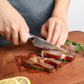 Takoizu serrated steak knife slicing cooked steak