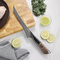 Titan Boning Knife arranged on a cutting board with fresh ingredients