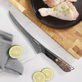Titan Boning Knife beside poultry and fresh ingredients