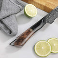 Close-up of the Titan Serrated Knife black resin and maple wood handle