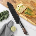 Titan Serrated Knife and leather sheath beside artisan bread