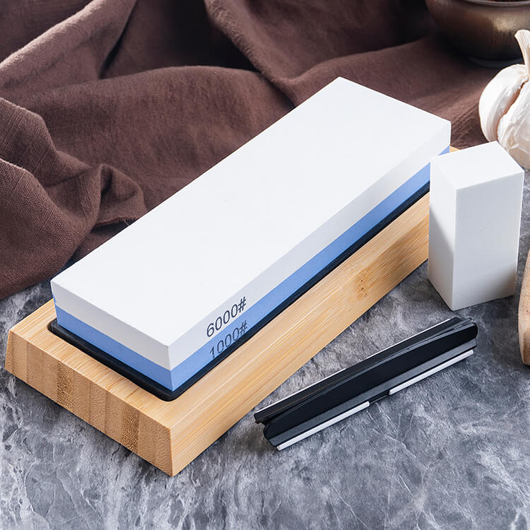A knife and sharpening stone on a table. Get the SEIDO 1000/6000 Grit Whetstone for a budget-friendly sharpening experience.
