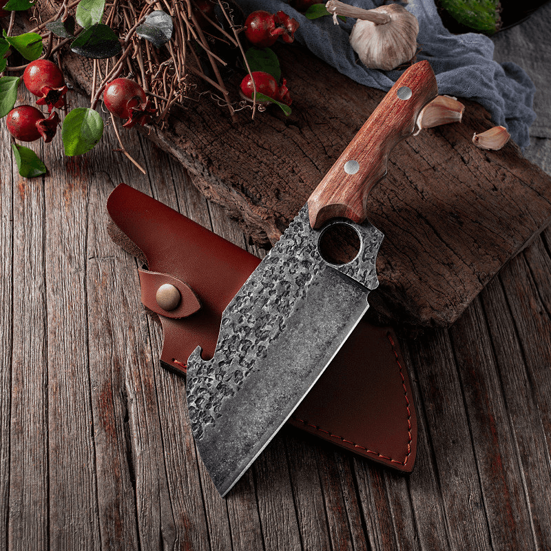 A Kemono Cleaver Knife from seido knives rests on a wooden table, accompanied by a bunch of fresh herbs.