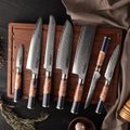 Behold the exquisite Hanikamu 7-Piece Damascus Chef Knife Set by Seido Knives, elegantly displayed on a cutting board.