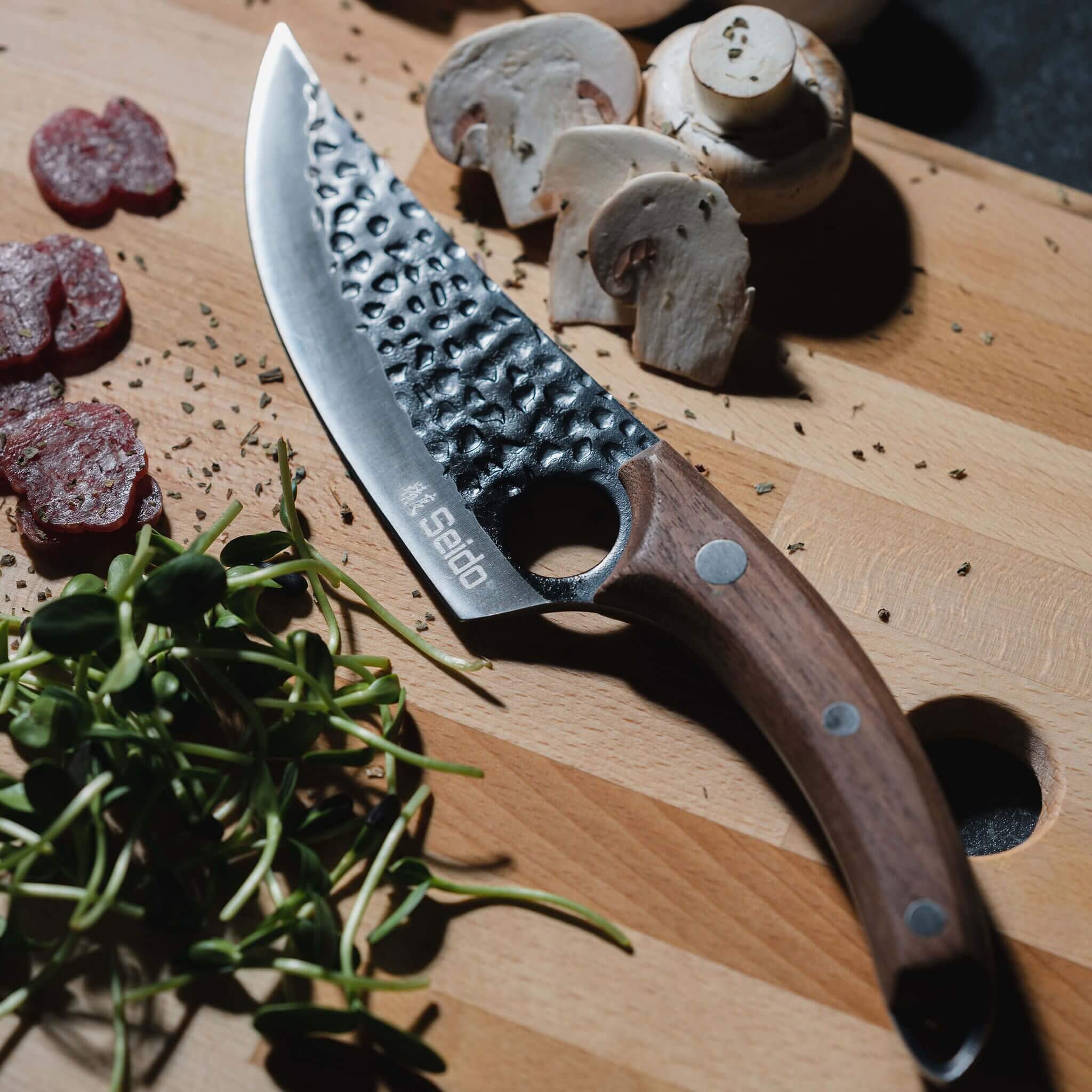 A Kyodai Utility Chef Knife and fresh mushrooms on a cutting board, ready for a delicious culinary adventure!
